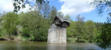 Log cabin on a bridge pillar
